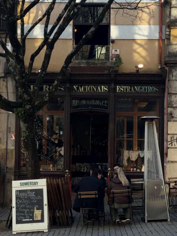 An old wine bar with tables outside and a chalkboard menu